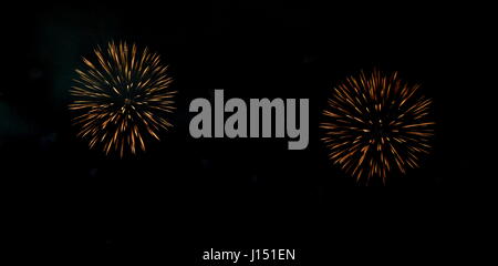 Festive fireworks in night sky. A single shot of the colorful fireworks in honor of the event. Firework multicolour fun and joyful. Different colors,  Stock Photo