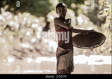 A school girl gold panner in the mountains near Ankavandra, Madagascar Stock Photo