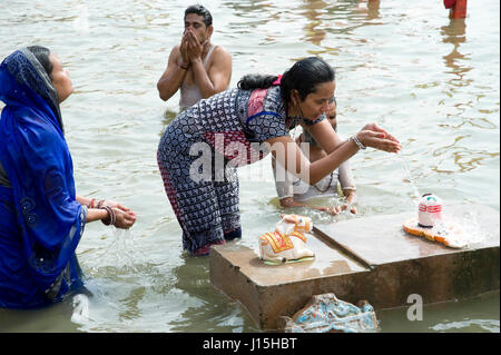 Woman praying offering water on shivling, ujjain, madhya pradesh, india, asia, Stock Photo