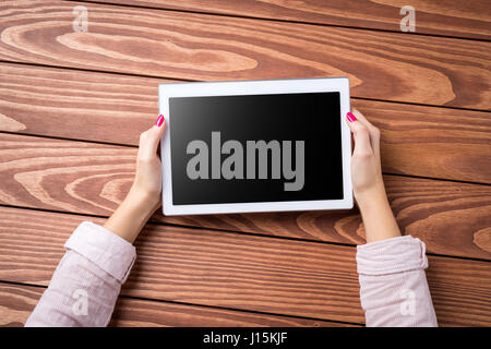 Woman holding white digital tablet Stock Photo