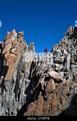 CA03238-00...CALIFORNIA - Hiker descending the rocky trail down from the summit of Mount Whitney. Stock Photo