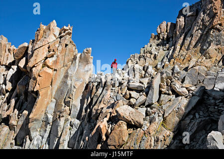 CA03239-00...CALIFORNIA - Hiker descending the rocky trail down from the summit of Mount Whitney. Stock Photo