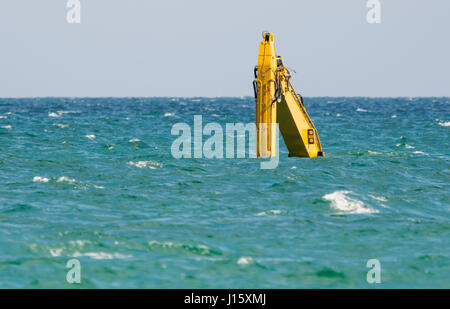 Submerged dredger in the sea after an accident in shallow water off the coast of Worthing, West Sussex, England, UK. Stock Photo