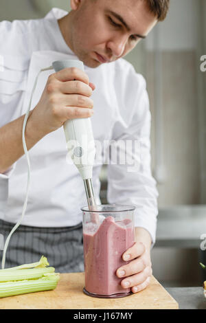 Young male preparing smoothie Stock Photo