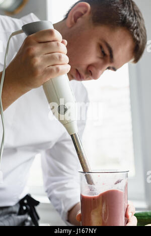 Young male preparing smoothie Stock Photo