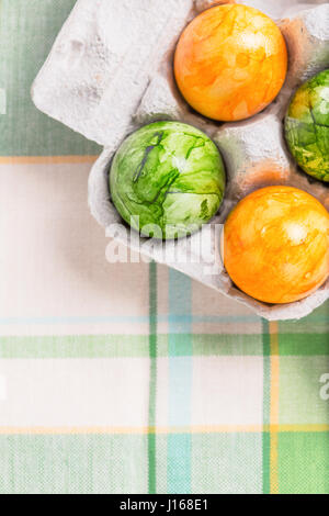 Top view of colored eggs in the box .Useful for food presentation background Stock Photo
