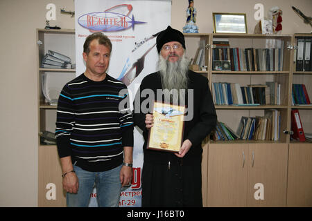 MOSCOW, RUSSIA: COULD THIS be the world’s most religious wannabe cosmonaut? Pictures show how the bearded Russian Orthodox priest practices his zero-G skills, travelled in a MiG fighter on a journey to the edge of space and most importantly takes the last confession of Russian cosmonauts before they leave the surface of our planet. Father Hegumen Iov is responsible for the souls of nearly all Russia’s cosmonauts, but the rector of Transfiguration Church in Russia’s Star City took his life in his hands by travelling in a MiG-29UB at 1,100 miles-per hour at over 11-miles above the surface of Ear Stock Photo