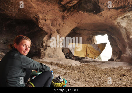 TURKEY: Shirine Taylor camped in a cave. CAN YOU survive off just £2K per year AND tour the world? This 21-year old university drop-out can show you how to do it while having the adventure of a lifetime. From washing laundry and cooking dinner over an open fire in the former Soviet Republic of Georgia to camping in the Indian Himalaya and staying with hospitable local families with a cycle and a budget of just six pounds fifty pence per day Shirine Taylor has travelled 7,500-miles from India all the way to Turkey. Stock Photo