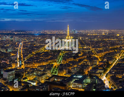 PARIS, FRANCE: The Eiffel Tower is lit up at dusk. A BRITISH aerial photographer has captured the human-built world in all its glory. From iconic landmarks like the jaw-dropping Christ the Redeemer of Rio to the shocking trash of a Spanish landfill site these pictures show the human footprint at both extremes. Other stunning pictures show the unforgettable New York skyline, Paris lit up and night as well as the everyday homes we live in and the infrastructure we need to survive in the modern world. Aerial photographer Peter Adams (55) travelled across the world to fly an R44 helicopter 90 mile Stock Photo