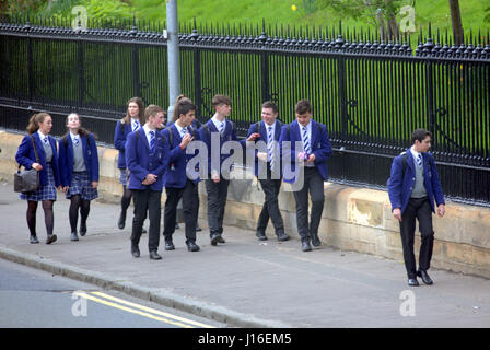 British school children on street messing about walking home from school the high school of Glasgow Stock Photo