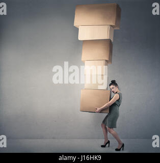 Woman carrying heavy boxes Stock Photo