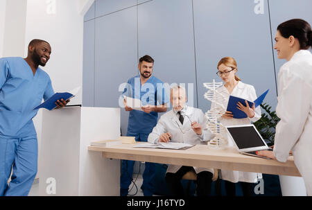 Interested mentor enjoying class with interns in the medical college Stock Photo