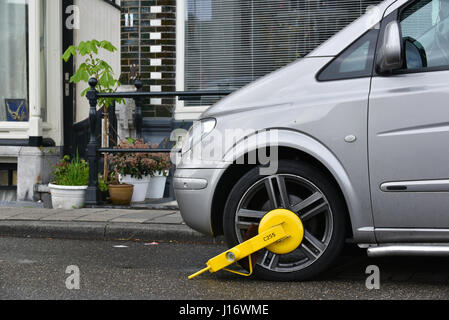 Clamped car in the restricted parking zone in the city centre of Amsterdam, Holland. Stock Photo