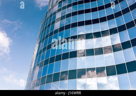 glass wall of the office building with white clouds reflection Stock Photo