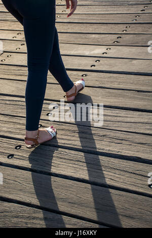 Rear view close up of a woman walking outdoors Stock Photo