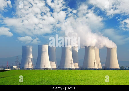 Nuclear power plant with yellow field and big blue clouds Stock Photo