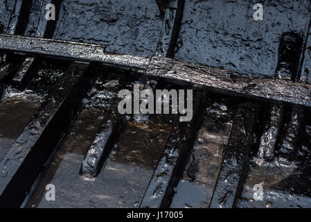 Tarred hull of a rowing boat, Varanasi Stock Photo