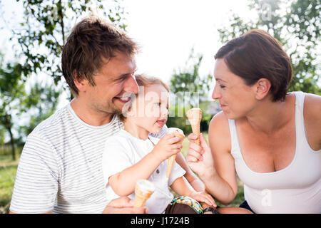 Father, mother and son eating ice cream, sunny summer Stock Photo