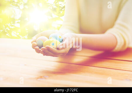 close up of woman hands with colored easter eggs Stock Photo