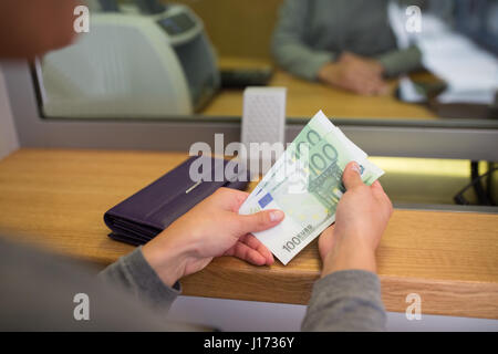 hands with money at bank or currency exchanger Stock Photo