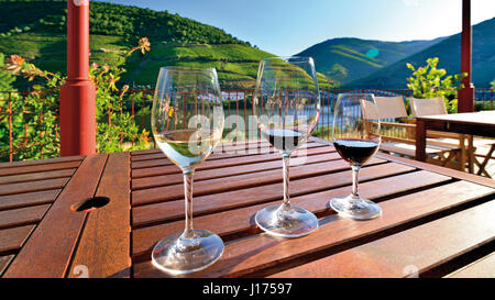 Portugal: Three wine glasses on a table with great view of river Douro Stock Photo