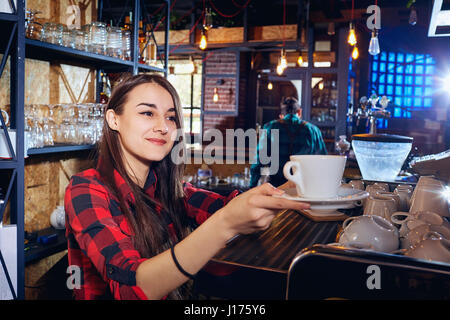 The barman girl works at bar in  restaurant Stock Photo