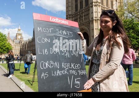 London, UK. 18 April 2017. Jessica Bridge of Ladbrokes displaying the odds for the Snap General Election outside the Houses of Parliament. Reactions to Prime Minister Theresa May calling a Snap General Election for 8 June 2017. Credit: Bettina Strenske/Alamy Live News Stock Photo
