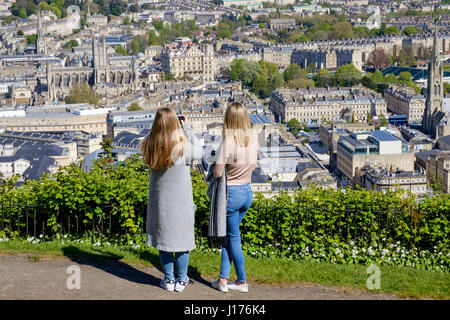 Bath, UK. 18th Apr, 2017. Two woman taking advantage of the warm spring sunshine and a high vantage point are pictured in Alexandra Park as they take photographs of the city of Bath. Credit: lynchpics/Alamy Live News Stock Photo