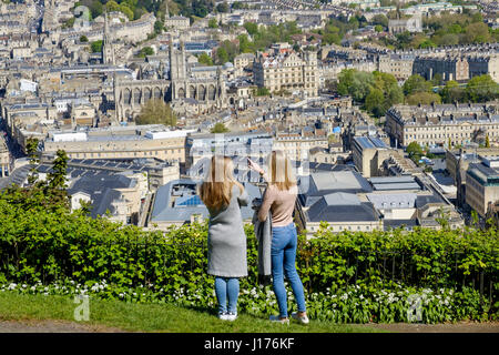 Bath, UK. 18th Apr, 2017. Two woman taking advantage of the warm spring sunshine and a high vantage point are pictured in Alexandra Park as they look down at the city of Bath. Credit: lynchpics/Alamy Live News Stock Photo