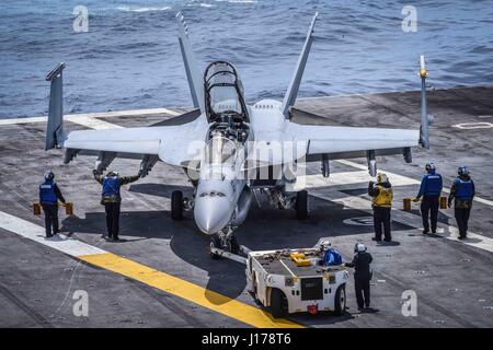 Uss Theodore Roosevelt, United States Of America. 17th Apr, 2017. U.S. Navy sailors park an F/A-18F Super Hornet fighter aircraft, assigned to the Redcocks of Strike Fighter Attack Squadron 22, on the flight deck aboard the Nimitz-class aircraft carrier USS Theodore Roosevelt April 17, 2017 in the Pacific Ocean. The aircraft carrier is underway conducting training off the coast of Southern California. Credit: Planetpix/Alamy Live News Stock Photo