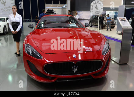 Doha, Capital of Qatar. 18th Apr, 2017. A model stands beside a Maserati Gran Turismo Sport during the Qatar Motor Show 2017 at the Doha Exhibition and Convention Center in Doha, Capital of Qatar, April 18, 2017. The five days of the show will witness hybrid cars, connected cars and some of the most tech-advanced vehicles in the world. Credit: Nikku/Xinhua/Alamy Live News Stock Photo