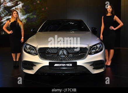 Doha, Capital of Qatar. 18th Apr, 2017. Models stand beside a Mercedes-AMG E43 4MATIC during the Qatar Motor Show 2017 at the Doha Exhibition and Convention Center in Doha, Capital of Qatar, April 18, 2017.The five days of the show will witness hybrid cars, connected cars and some of the most tech-advanced vehicles in the world. Credit: Nikku/Xinhua/Alamy Live News Stock Photo