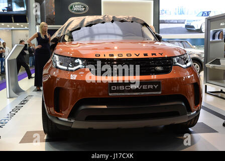 Doha, Capital of Qatar. 18th Apr, 2017. A model unveils a Land Rover discovery during the Qatar Motor Show 2017 at the Doha Exhibition and Convention Center in Doha, Capital of Qatar, April 18, 2017. The five days of the show will witness hybrid cars, connected cars and some of the most tech-advanced vehicles in the world. Credit: Nikku/Xinhua/Alamy Live News Stock Photo