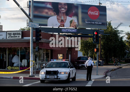 Los Angeles, USA. 18th Apr, 2017. A police officer stands guard in Fresno, California, the United States, on April 18, 2017. Three people were killed as a man went on a shooting spree in central Fresno, California on Tuesday and later surrendered to police, the Fresno Police Department said. Credit: Li Qibing/Xinhua/Alamy Live News Stock Photo
