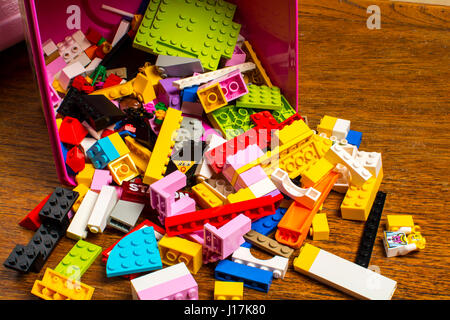 A scattering  of Lego bricks,blocks, bits and pieces falling out of a box Stock Photo