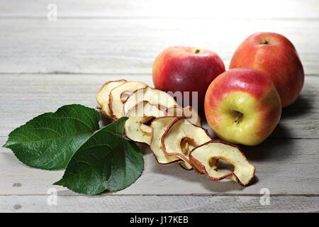 homemade dried apple rings on wooden background Stock Photo
