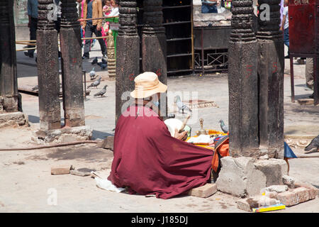 Holy man praying at Swayambhu / Swayambhunath, Kathmandu, Nepal Stock Photo