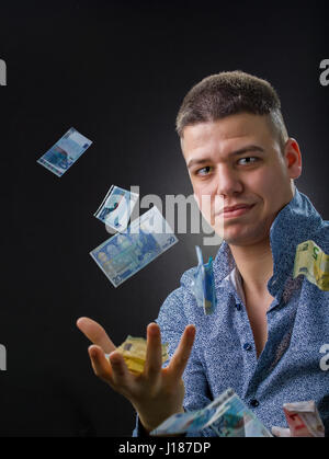 Business man with money bills flying around Stock Photo