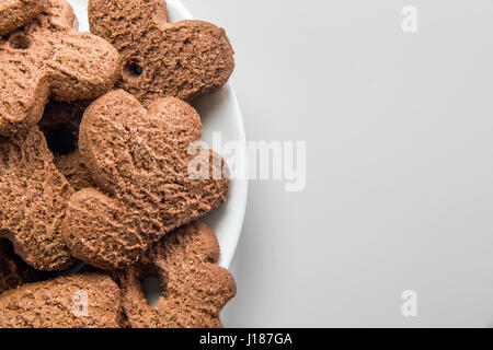 Several chocolate cookies over white dish Stock Photo