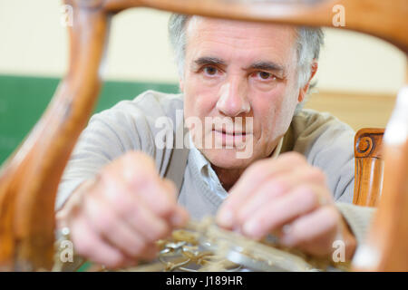 Repairing a damaged chair Stock Photo