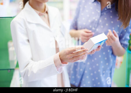 Female patient reading medicine label Stock Photo