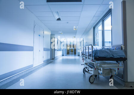 Bereavement, death or loss concept shot of empty bed, gurney or stretcher with drip in hospital corridor Stock Photo
