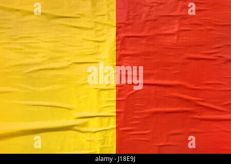 Yellow and red printed poster paper texture as background, useful for sport club team supporters placard or banner Stock Photo