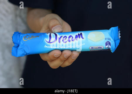 Hand holding Australia Cadbury white chocolate bar isolated Stock Photo