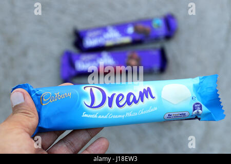 Hand holding Australia Cadbury white chocolate bar isolated Stock Photo