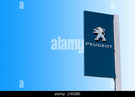 Samara, Russia - MAY 14, 2016: Official dealership sign of Peugeot against the blue sky background. Peugeot is a French car brand, automotive manufact Stock Photo