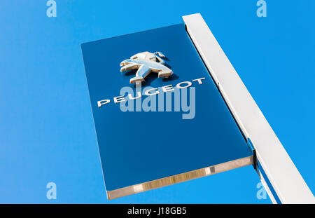 Samara, Russia - MAY 14, 2016: Official dealership sign of Peugeot against the blue sky background. Peugeot is a French car brand, automotive manufact Stock Photo