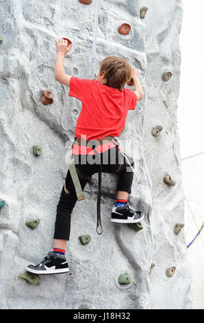 A teenage boy on a Climbing Wall Stock Photo