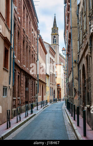 Narrow street  in old center of Toulouse, France. Stock Photo