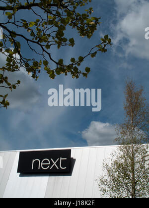 Calcot, Reading, Bath Road, Berkshire, England - April 18, 2017: Next women and men fashion clothing store sign over premises Stock Photo